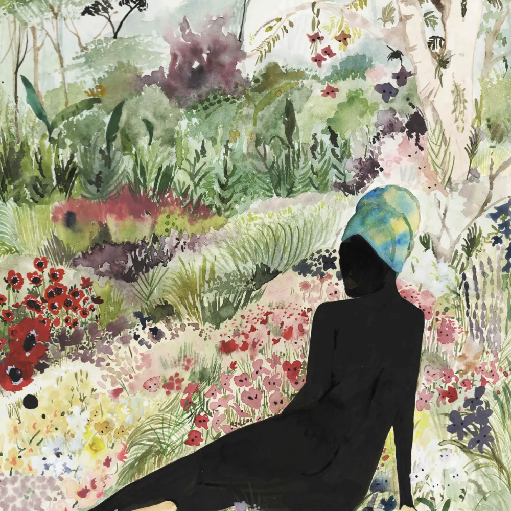 Silhouette of a woman sitting in flowers