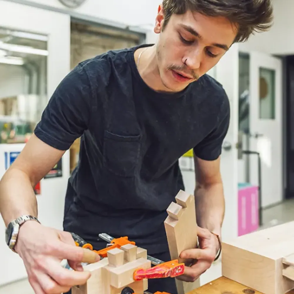 Student working at wood working table