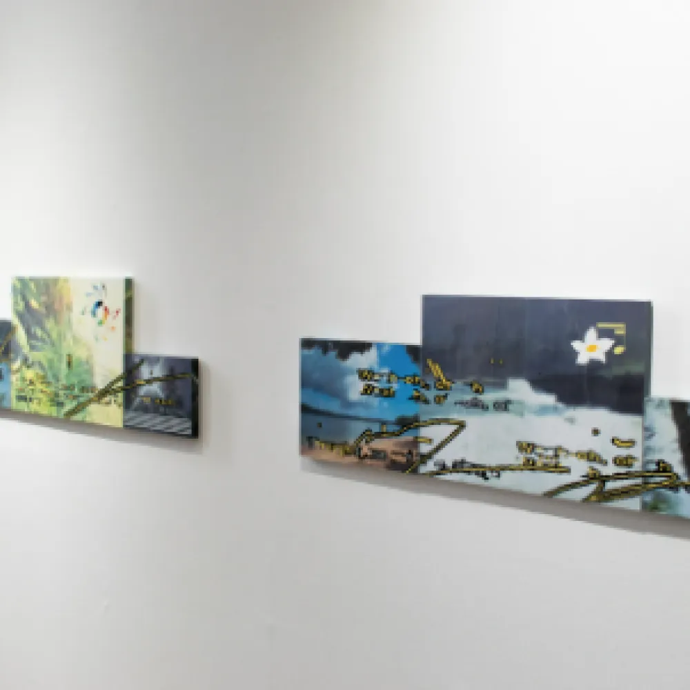 Paintings hung on a gallery wall