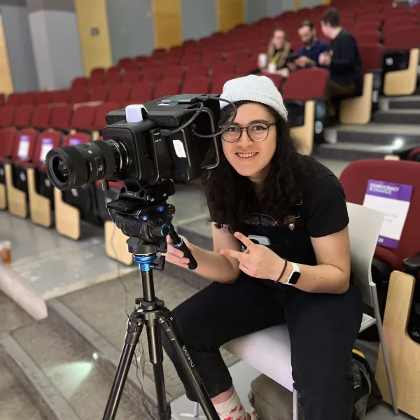 Student operating a camera