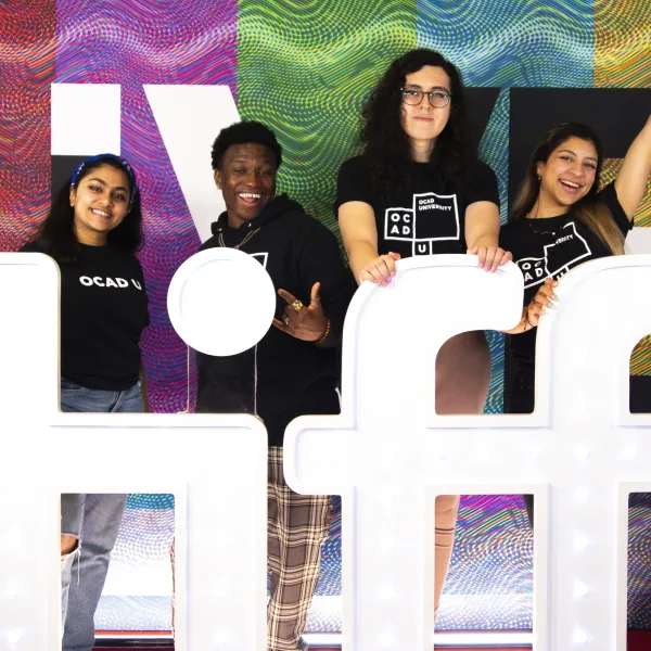 Students posing in front of the TIFF logo
